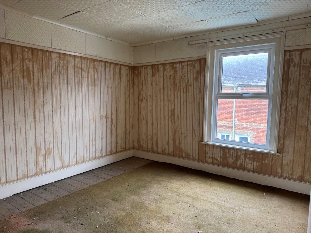 Lot: 133 - FREEHOLD TOWN CENTRE HOUSE FOR IMPROVEMENT - Bedroom with window and ceiling tiles
